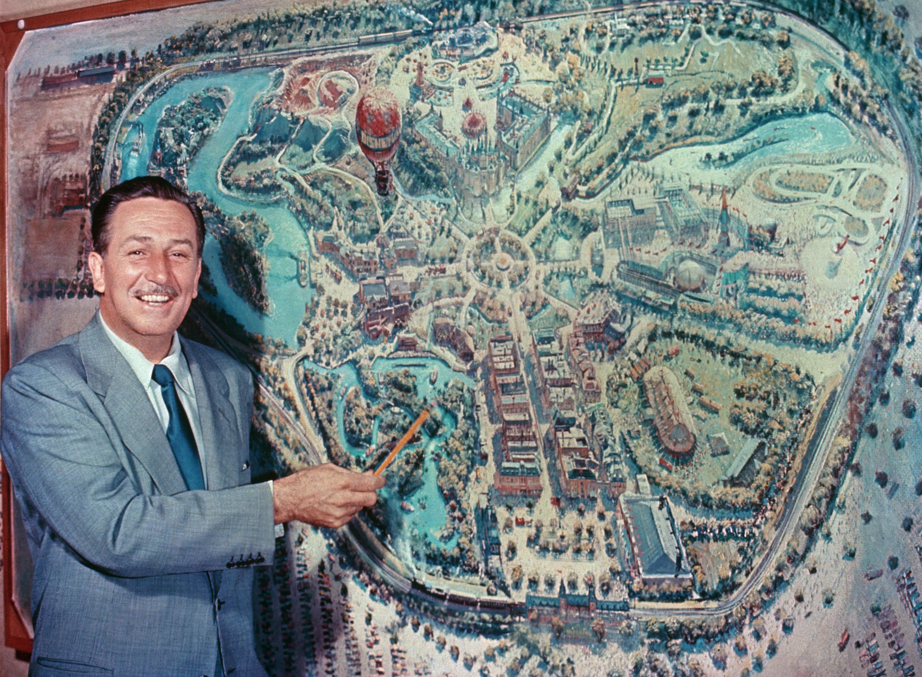 Walt Disney in front of a map of Disneyland, Anaheim